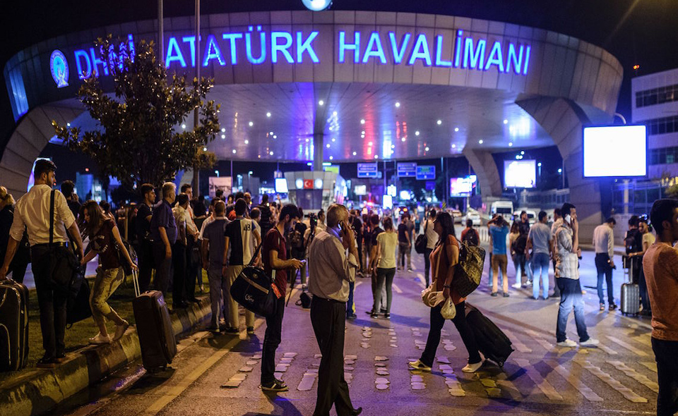 EDITORS NOTE: Graphic content / People stand outside the entrance as they leave the airport after two explosions followed by gunfire hit the Turkey's biggest airport of Ataturk in Istanbul, on June 28, 2016. 
At least 10 people were killed on June 28, 2016 evening in a suicide attack at the international terminal of Istanbul's Ataturk airport, Turkish Justice Minister Bekir Bozdag said. Turkey has been hit by a string of deadly attacks in the past year, blamed on both Kurdish rebels and the Islamic State jihadist group. / AFP / OZAN KOSE        (Photo credit should read OZAN KOSE/AFP/Getty Images)