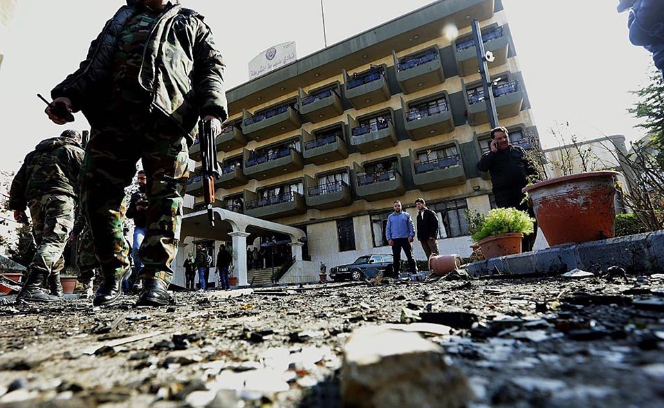 Syrian security forces inspect the site of a suicide attack at a police officer's club in the Masaken Barzeh district of the capital Damascus on February 9, 2016.    
The Syrian Observatory for Human Rights said about 20 people had also been wounded, adding that policemen were among the dead and injured.

 / AFP / LOUAI BESHARA        (Photo credit should read LOUAI BESHARA/AFP/Getty Images)