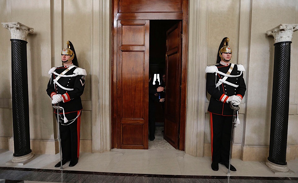 Corazzieri presidential honor guard officers patrol the entrance of the studio where Italian President Giorgio Napolitano meets party representatives at Rome's Quirinale presidential palace Saturday Dec. 22, 2012. Italy's President Napolitano is meeting with political leaders to set the stage for general elections early next year as Premier Mario Monti weighs whether to run for office after having handed in his resignation. Monti, appointed 13 months ago to steer Italy away from a Greek-style debt crisis, stepped down Friday after ex-Premier Silvio Berlusconi's party yanked its support for his technical government. (AP Photo/Alessandra Tarantino)